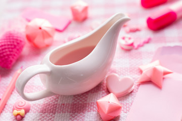 Valentine's day holiday celebration with cup of strawberries milk and Valentine's day composition on Pink tablecloth background.