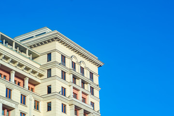 Old high-rise building on a background of blue sky