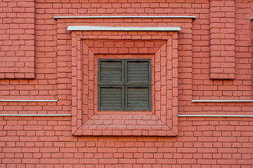 Fototapeta na wymiar Shuttered window in decorative brick wall