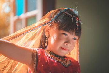 Happy little girl smiling in India suit.