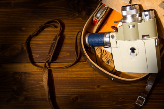 Vintage Super 8 cine camera from the 1960 Minolta Zoom 8 with his original case on wooden background