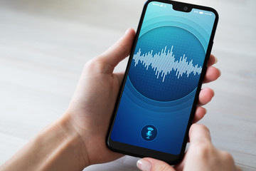 Voice recognition application on smartphone screen. Artificial intelligence and deep learning concept.