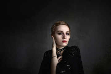 Fototapeta premium Girl with short hair holds hands around face