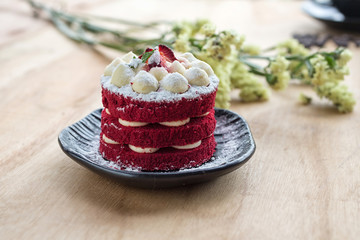Thai Cake. Velvet red cake. Cookies and Strawberry decorated with red cake on wooden table and flower.