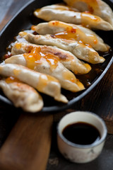 Close-up of fried asian dumplings with dipping sauces, selective focus