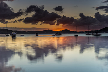 Sunrise and Cloud Reflections on the Bay with Boats