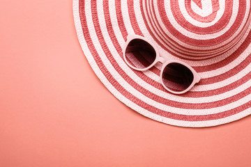 Female striped summer romantic Hat On Living coral background. Concept of summer holidays
