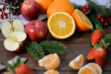 fruits on wooden background. Citrus fruits in rustic background ,oranges, strawberries , mandarins, clementines , apples . Healthy eating and dieting concept. Winter assortment