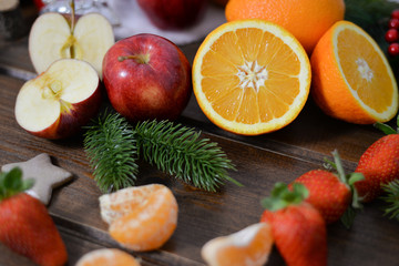 Naklejka na ściany i meble fruits on wooden background. Citrus fruits in rustic background ,oranges, strawberries , mandarins, clementines , apples . Healthy eating and dieting concept. Winter assortment