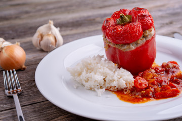 baked filled pepper,garlic and onion on wooden ground