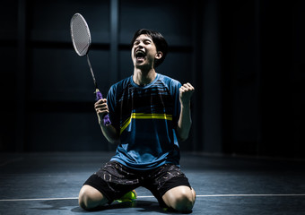 Asian badminton player is glad that he wins.competition © torwaiphoto