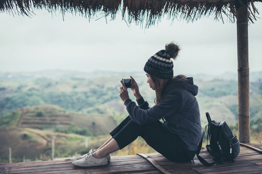 Young woman traveler using smart phone to taking photo