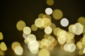 Abstract bokeh background of defocused lights. Merry Christmas and New Year background. Holiday glowing background and wallpaper. Blurred Bokeh.