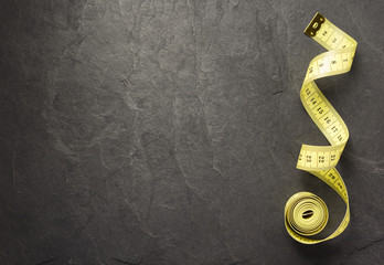 tape measure on slate stone background