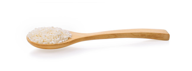 Japanese rice in a wooden spoon on white background.