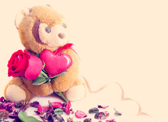  Teddy bear holding a rose and heart.The concept of Valentine's Day