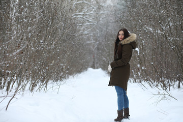 Beautiful girl in a beautiful winter park