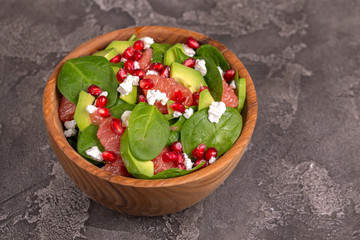 Tasty salad with grapefruit, spinach, feta, avocado and pomegranate