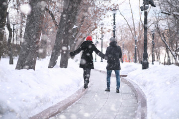 Fototapeta na wymiar Young couple walking through the winter