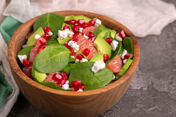 Tasty salad with grapefruit, spinach, feta, avocado and pomegranate