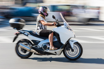 Fototapeta na wymiar Scooter driver at, Piazza Caricamento, Genoa, Liguria, Italy, July 2013