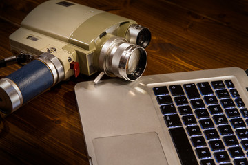 Contrast between different periods of technology: a vintage Super 8 cine camera from the 1960...