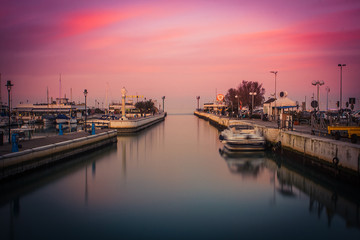 View of the Port at sunset. Long exposure picture in Riccione, Emilia Romagna, Italy. - obrazy, fototapety, plakaty