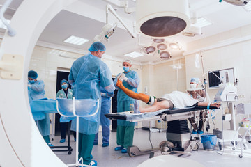 doctor and an assistant in the operating room for surgical venous vascular surgery clinic