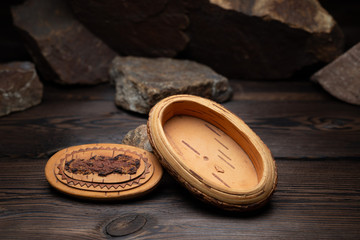 a small box of birch bark on a dark background
