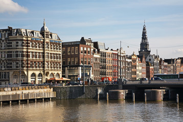Fototapeta na wymiar Damrak street and Oude Kerk – Old church in Amsterdam. Netherlands