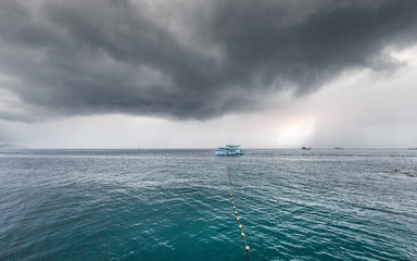 Traveling boat with passenger go to island while raining strom near comes