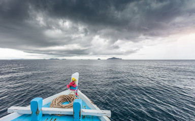 Traveling boat go to island while raining strom near comes
