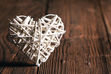 Wicker heart on wooden background