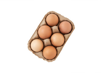 Fresh brown eggs in carton on wooden table


