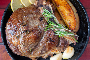 Juicy grilled beef steak with baked potatoes. Close-up. Top view.