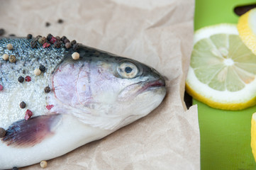 Fresh red fish spice and lemon. Raw trout is prepared for cooking. Close-up