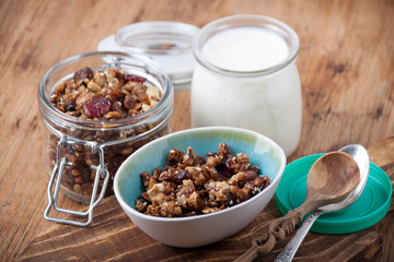Homemade granola in glass jar  and   yogurt  a breakfast