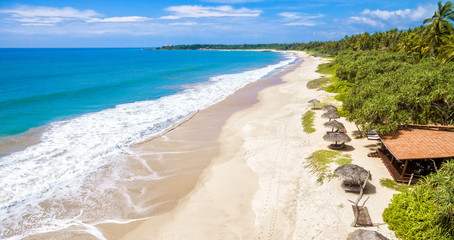 Panoramic view of the tropical beach with umbrellas, Sri Lanka