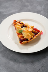 One slice of fruits pie on plate