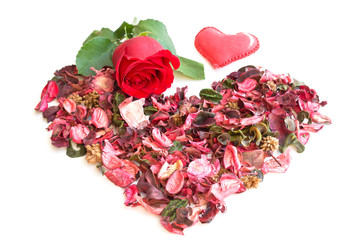 Heart made of dried rose petals, red rose is alive and textile heart on white background
