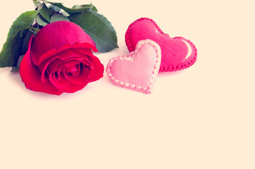 Red rose textile and two hearts - red and pink