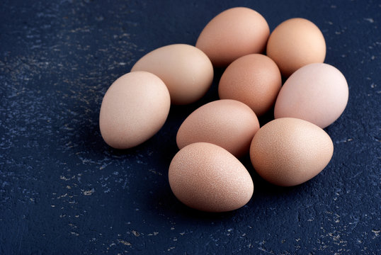 Eggs of guinea fowl on blue background closeup