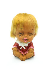 Cute little doll sitting on white background