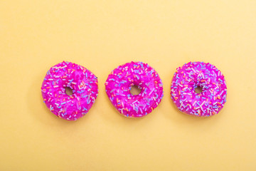 pink donuts on yellow background 