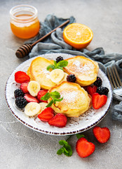Delicious pancakes with berries on a concrete backrgound