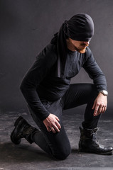 Portrait of a masked super hero on black background.