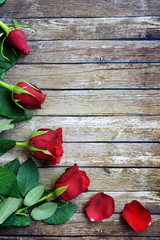 Red roses flower on the wooden background with copy space