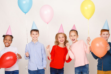 Children with balloons having fun at birthday party