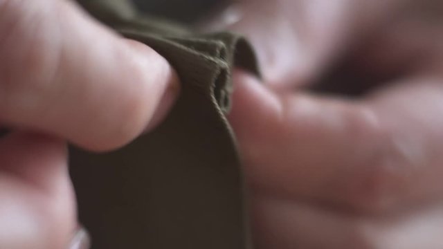 hands close-up macro sewing clothes needle