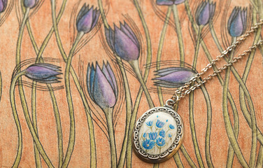 Handmade enamel pendant with blue flowers on loral pattern with gosling wind flower in vintage style background
